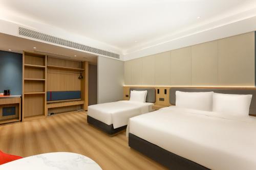 a hotel room with two beds and a television at Holiday Inn Express Nanjing Xi'anmen by IHG in Nanjing