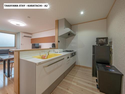 a kitchen with a sink and a refrigerator at Takayama Stay Karatachi in Takayama