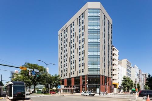 a tall building on a city street with at The knot Sapporo - Vacation STAY 96522v in Sapporo