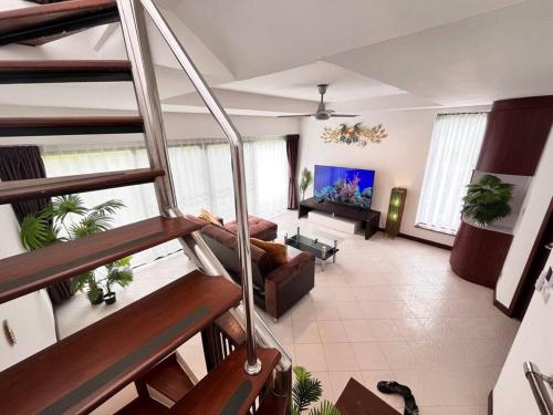 a large living room with a couch and a tv at Samui Sabai Haus mit Dachterrasse und Pool in Koh Samui 