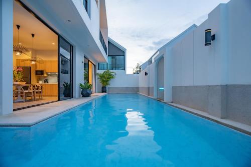 a swimming pool in the middle of a house at Modern 4BR Villa with Private Pool in Bangtao in Bang Tao Beach