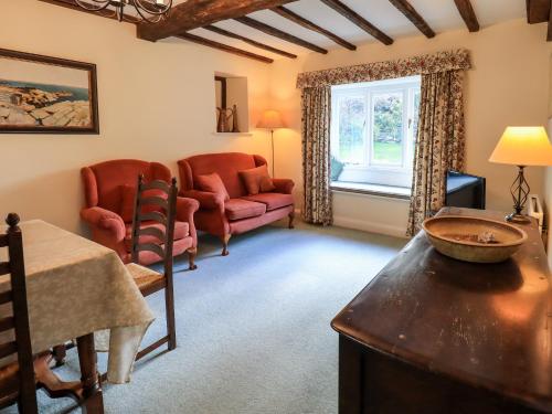 a living room with a couch and a chair at Ecclerigg Old Farm in Ambleside