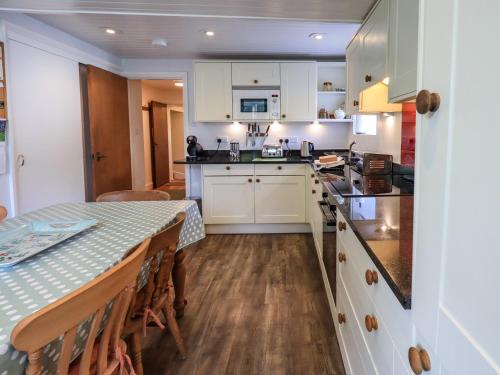 a kitchen and dining room with a table and chairs at Ecclerigg Old Farm in Ambleside