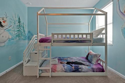 a room with two bunk beds in a room at Luxury 12-BR Villa w/ Pool & Resort Amenities Near Disney in Kissimmee