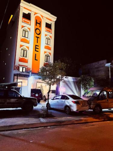 a building with cars parked in front of it at Love Hotel Hóc Môn in Ho Chi Minh City