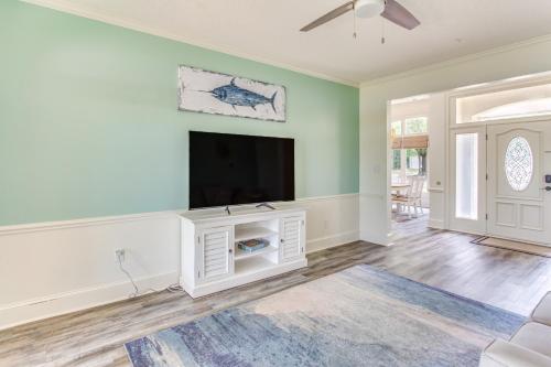 a living room with a flat screen tv on a wall at Walk to Marina Pet-Friendly Little River Home! in Little River