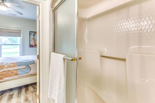 a bathroom with a refrigerator and a bed at Walk to Marina Pet-Friendly Little River Home! in Little River