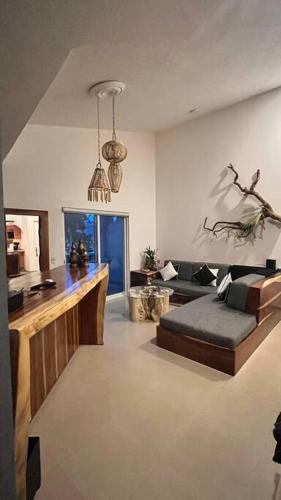a living room with a couch and a table at Departamento Rubi en Diamante Lakes in Acapulco