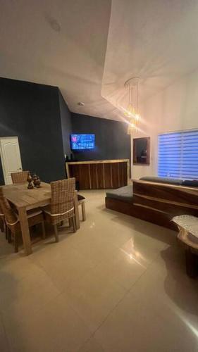 a living room with a table and a tv at Departamento Rubi en Diamante Lakes in Acapulco