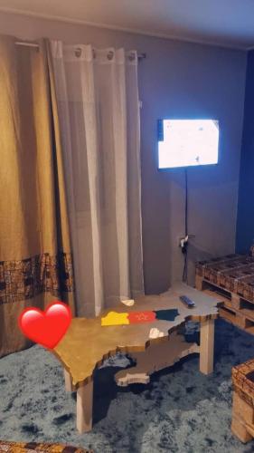 a living room with a table with a heart on it at Résidence Karamel Yaoundé Anguissa in Yaoundé