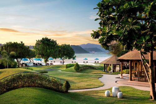 a view of a golf course with a resort at The Naka Island, a Luxury Collection Resort & Spa, Phuket in Ko Naka