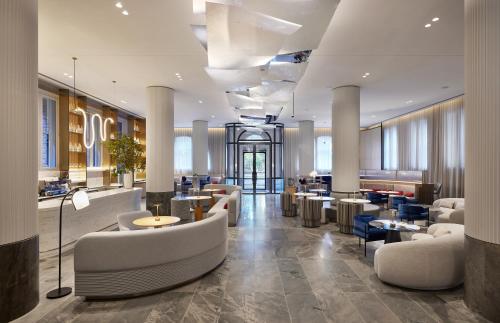 a lobby of a hotel with couches and tables at Lanson Place Parliament Gardens in Melbourne