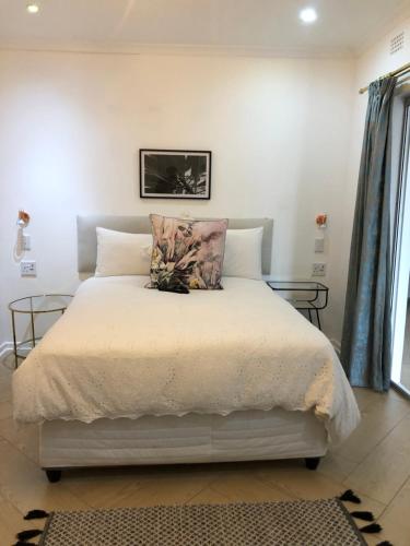 a bedroom with a bed with a pillow on it at Bluebanana Lodge in Mthatha