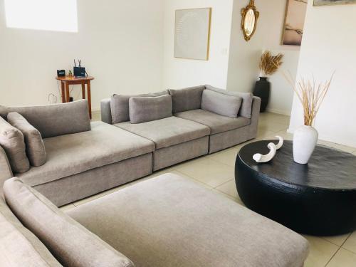 a living room with a couch and a table at Bluebanana Lodge in Mthatha