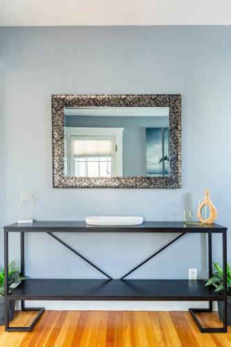 a dressing table with a mirror on a blue wall at Let us help you make Salem a place to remember! in Salem
