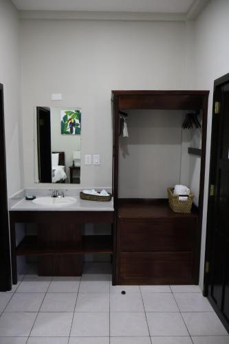 a bathroom with a sink and a mirror at The Toucan Inn in Independence