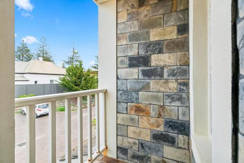 a faux stone wall on a balcony of a house at Coastal Luxury 3-Bed Townhouse 150m from Beach in Glenelg
