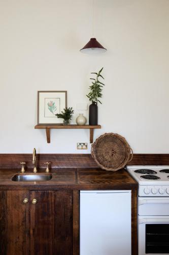 a kitchen with a sink and a stove at Woolmers Estate in Longford