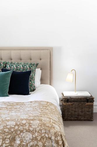 a bedroom with a bed and a lamp on a table at Alkina Old Quarter Luxury Accommodation in Greenock