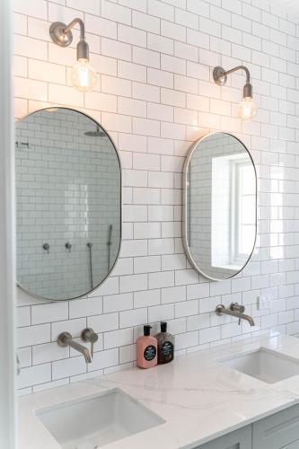 a bathroom with two sinks and two mirrors at Alkina Old Quarter Luxury Accommodation in Greenock