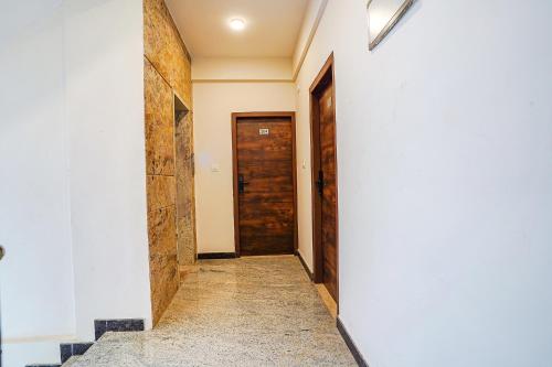 a corridor of a house with two doors at FabHotel The Pearl Boutique - Electronic City in Bengaluru