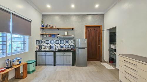 a kitchen with a refrigerator and a counter top at Sanssouci Kep in Kep