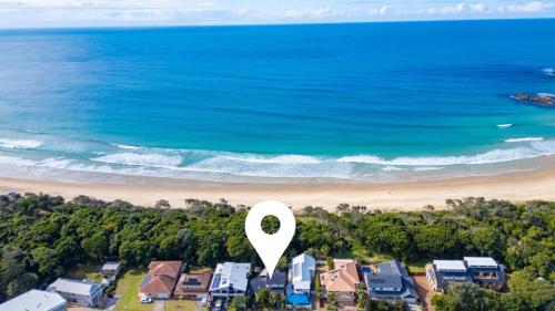 an aerial view of a beach with a white marker at Beached - Prime beachfront location in Sawtell