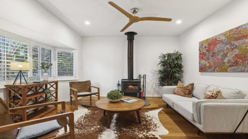 a living room with a couch and a wood stove at Beached - Prime beachfront location in Sawtell