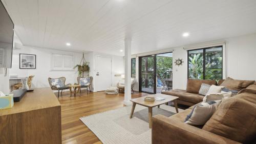 a living room with a couch and a table at Beached - Prime beachfront location in Sawtell