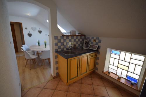 a small kitchen with a sink and a table at Au pied du Haut Koenigsbourg 2 in Saint-Hippolyte