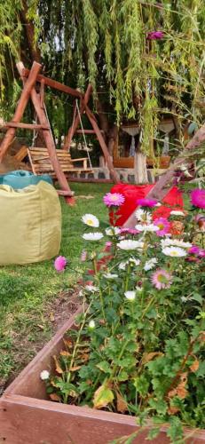 a garden with pink flowers and a swing at GreenField Resort in Yeghegnadzor