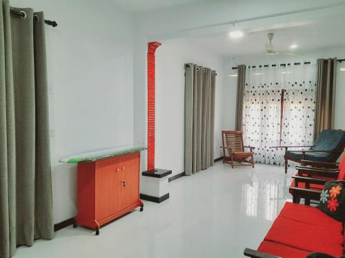 a room with a bed and a table and chairs at Rustic Villa 7 in Weligama