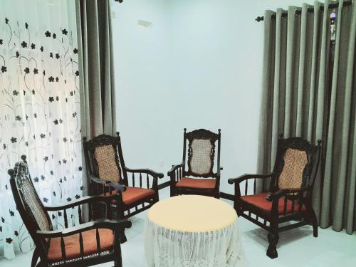 a group of chairs and a table in a room at Rustic Villa 7 in Weligama
