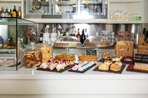 a display case with different types of pastries and cakes at Boutique Hotel Sirmione in Sirmione