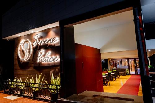 a neon sign on the wall of a restaurant at Hotel Serene Palace in Port Blair