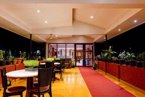 a restaurant with tables and chairs and a red carpet at Hotel Serene Palace in Port Blair