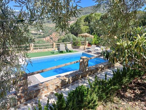 a swimming pool in a villa with a garden at Villa Jael in El Gastor