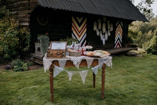 a table with food on it in front of a cabin at Kiisa Jahi- ja Matkamaja in Holvandi