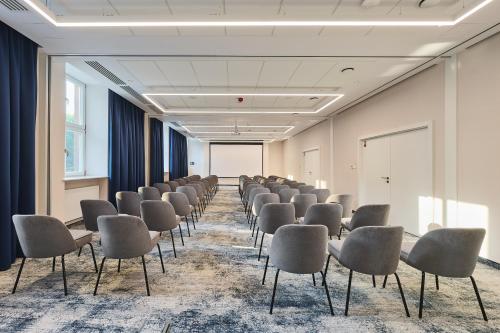 a room with rows of chairs and a whiteboard at Aiden by Best Western Lodz in Łódź
