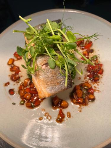 a plate of food with a piece of fish and beans at The Ship Inn - Winner Best Hotel Experience 2024 Visit Scotland in Gatehouse of Fleet