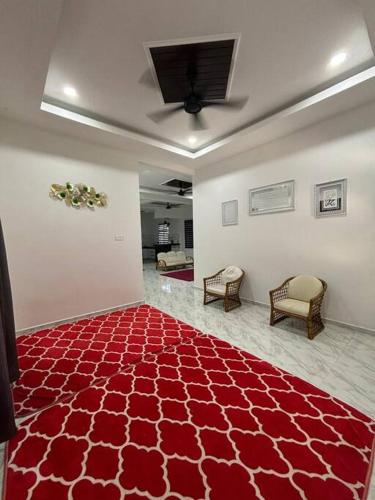 a room with a red rug on the floor at Hannan Homestay Kuala Terengganu in Kuala Terengganu