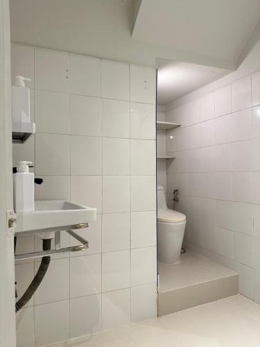 a bathroom with a toilet and a sink at Nap by Snooze in Bangkok