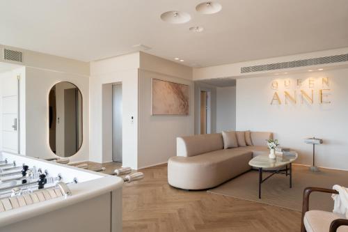 a living room with a couch and a table at Queen Anne - Penthouse apartment with private pool in Eilat