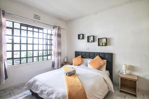 Postel nebo postele na pokoji v ubytování North Manor Nakuru