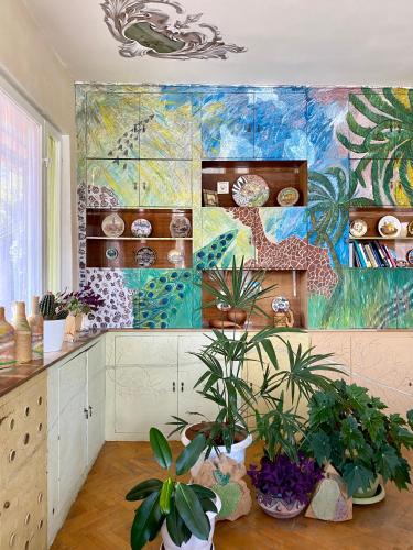 a room with plants and a painting on the wall at Vanadzor Family Art House in Vanadzor