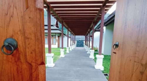 a corridor of a building with a walkway at Villa Mae Hong Son in Mae Hong Son