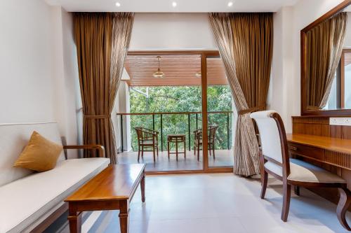 a living room with a couch and a table at Le Montfort Resort in Munnar