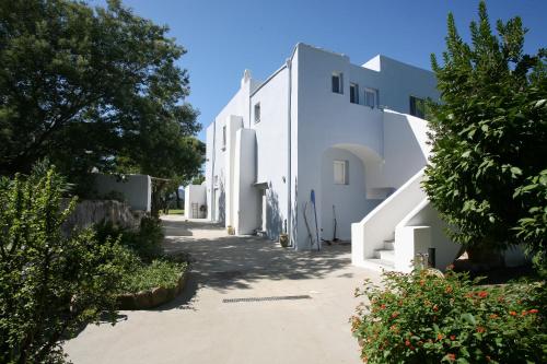 a row of white buildings on a street at Il Carrubo in Procida