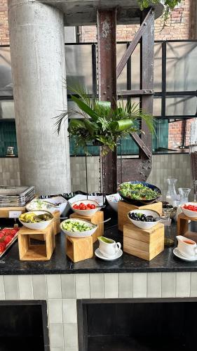 a buffet with many bowls of food on a table at Cukrownia Żnin in Żnin
