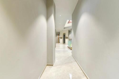 an empty hallway with white walls and a white wall at FabHotel Prime The Grey Circle in Indore